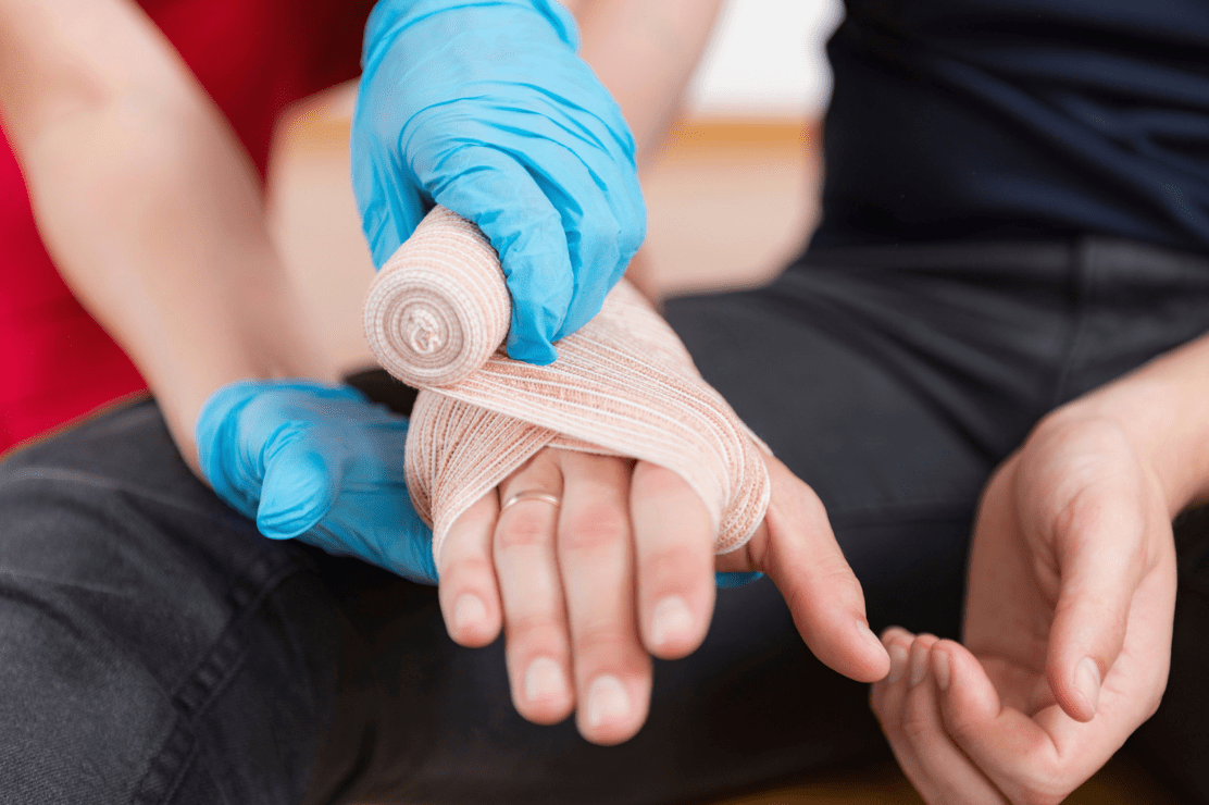 Man wrapping a hand in a bandage